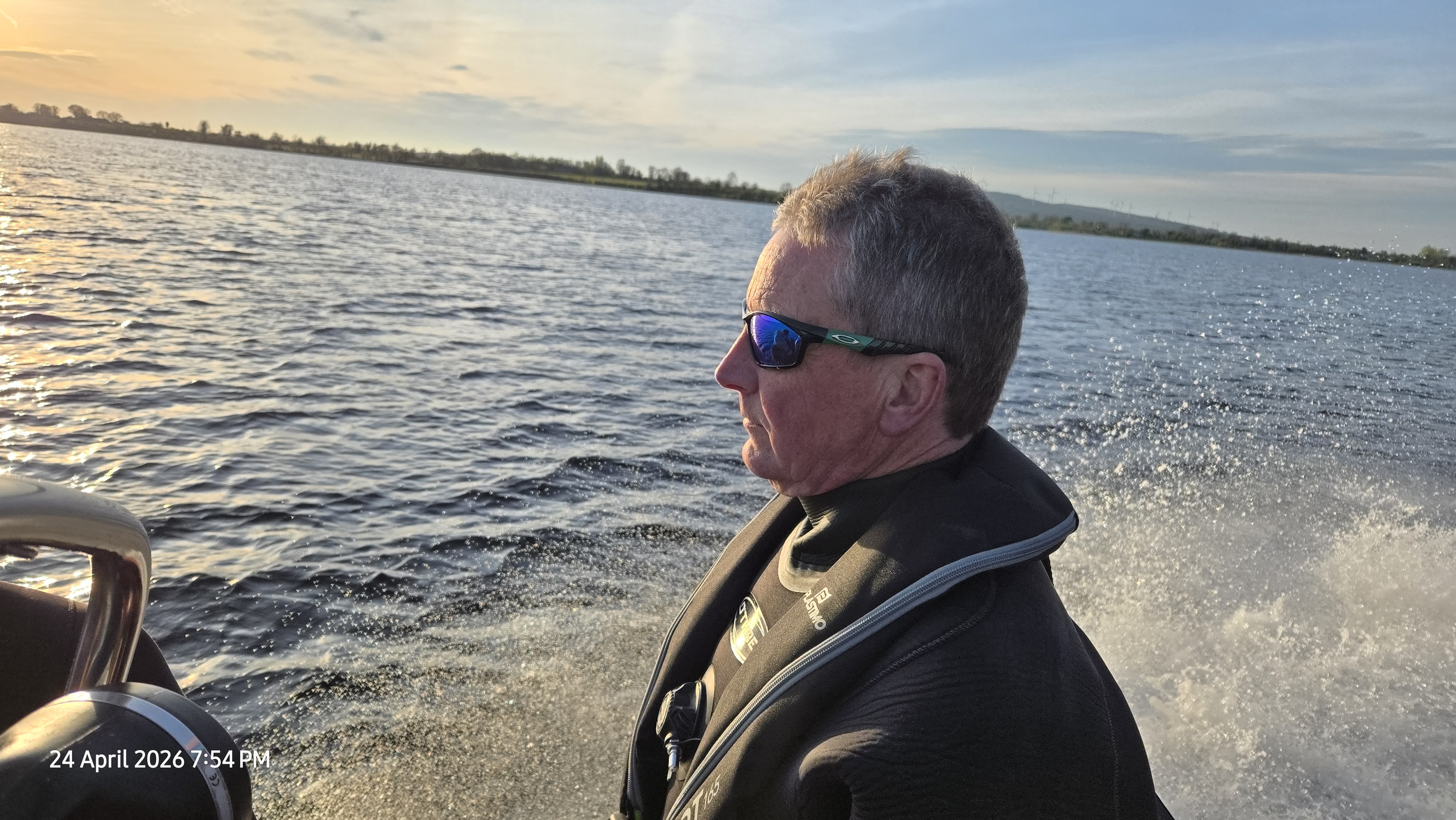 Club member seated on the boat at sunset